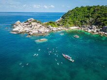 Aerial View Of Group Snorkeling And Swimming In Transparent Sea In Shark Bay On Ko Tao Island, Thailand.