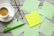 © Svetlana - note paper, yellow sticker and a cup with coffee glasses on the table. Mockup on office copy space background. It is important not to forget the note