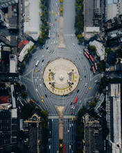 Aerial View Of The Vehicles Driving Next To The Democracy Monument At The Roundabout In Bangkok Downtown, Thailand.