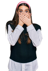 Wall Mural - Young beautiful woman wearing casual white shirt shocked covering mouth with hands for mistake. secret concept.