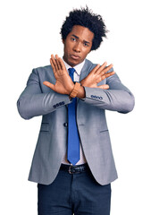 Canvas Print - Handsome african american man with afro hair wearing business jacket rejection expression crossing arms doing negative sign, angry face