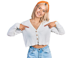 Poster - Beautiful young blonde woman wearing casual white sweater looking confident with smile on face, pointing oneself with fingers proud and happy.