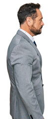 Poster - Middle age man wearing business clothes looking to side, relax profile pose with natural face and confident smile.