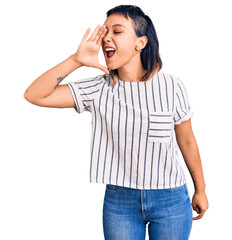 Wall Mural - Young woman wearing casual clothes shouting and screaming loud to side with hand on mouth. communication concept.