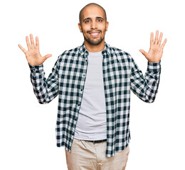 Canvas Print - Hispanic adult man wearing casual clothes showing and pointing up with fingers number ten while smiling confident and happy.