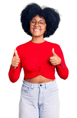 Sticker - Young african american girl wearing casual clothes and glasses success sign doing positive gesture with hand, thumbs up smiling and happy. cheerful expression and winner gesture.