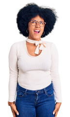 Sticker - Young african american girl wearing casual clothes and glasses angry and mad screaming frustrated and furious, shouting with anger. rage and aggressive concept.