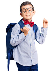 Sticker - Cute blond kid wearing nerd bow tie and backpack surprised with an idea or question pointing finger with happy face, number one