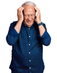 Wall Mural - Senior man with grey hair wearing casual shirt and glasses suffering from headache desperate and stressed because pain and migraine. hands on head.