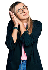 Canvas Print - Hispanic young woman wearing business jacket and glasses sleeping tired dreaming and posing with hands together while smiling with closed eyes.