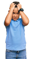 Sticker - Little boy hispanic kid wearing casual clothes suffering from headache desperate and stressed because pain and migraine. hands on head.