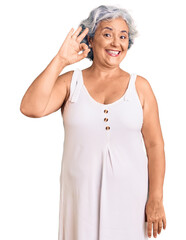 Canvas Print - Senior woman with gray hair wearing casual clothes smiling positive doing ok sign with hand and fingers. successful expression.