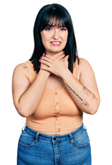 Sticker - Young hispanic plus size woman wearing casual clothes shouting and suffocate because painful strangle. health problem. asphyxiate and suicide concept.