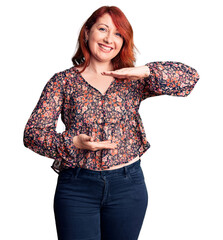 Sticker - Young beautiful redhead woman wearing casual t-shirt gesturing with hands showing big and large size sign, measure symbol. smiling looking at the camera. measuring concept.