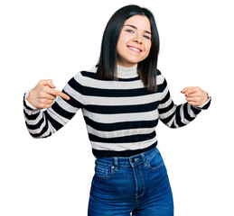 Poster - Young brunette woman with blue eyes wearing casual striped sweater looking confident with smile on face, pointing oneself with fingers proud and happy.