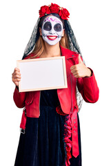 Sticker - Woman wearing day of the dead costume holding empty white chalkboard smiling happy and positive, thumb up doing excellent and approval sign