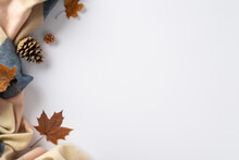 Indulge In Cozy Autumn Comfort At Home: Top View Photo Featuring A Warming Cashmere Plaid, Maple Foliage And Pinecones On A White Isolated Background. Copyspace Available For Text Or Adverts
