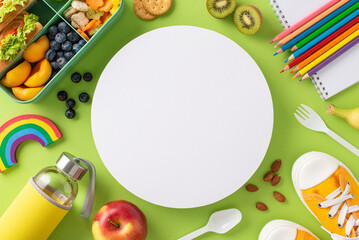 Paint picture of lunchtime bliss with an above view shot of lunchbox packed with sandwiches, fruits, veggies and bottle on green isolated background, empty circle for text or promotional content