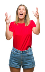 Poster - Young beautiful woman over isolated background crazy and mad shouting and yelling with aggressive expression and arms raised. Frustration concept.