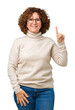 Beautiful middle ager senior woman wearing turtleneck sweater and glasses over isolated background showing and pointing up with finger number one while smiling confident and happy.
