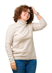 Canvas Print - Beautiful middle ager senior woman wearing turtleneck sweater and glasses over isolated background Smiling confident touching hair with hand up gesture, posing attractive