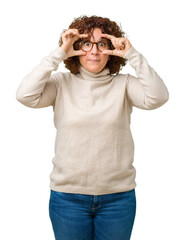 Poster - Beautiful middle ager senior woman wearing turtleneck sweater and glasses over isolated background Trying to open eyes with fingers, sleepy and tired for morning fatigue