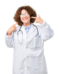 Poster - Middle ager senior doctor woman over isolated background smiling confident showing and pointing with fingers teeth and mouth. Health concept.