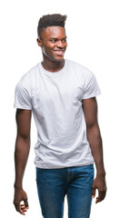 Canvas Print - Young african american man over isolated background looking away to side with smile on face, natural expression. Laughing confident.