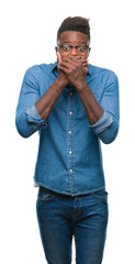 Canvas Print - Young african american man over isolated background shocked covering mouth with hands for mistake. Secret concept.