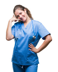 Poster - young brunette doctor girl wearing nurse or surgeon uniform over isolated background smiling doing p