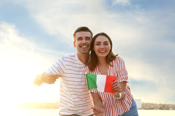 Sticker - Happy young couple with Italian flag outdoors