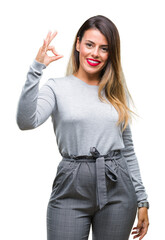 Poster - Young beautiful worker business woman over isolated background smiling positive doing ok sign with hand and fingers. Successful expression.