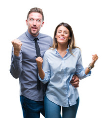 Wall Mural - Young workers business couple over isolated background celebrating surprised and amazed for success with arms raised and open eyes. Winner concept.