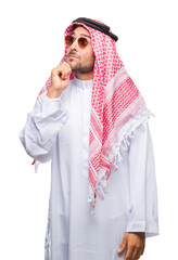 Sticker - Young handsome man wearing keffiyeh over isolated background with hand on chin thinking about question, pensive expression. Smiling with thoughtful face. Doubt concept.