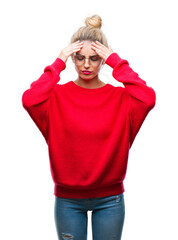 Wall Mural - Young beautiful blonde woman wearing red sweater and glasses over isolated background with hand on head for pain in head because stress. Suffering migraine.