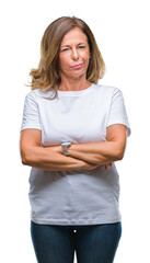 Sticker - Middle age senior hispanic woman over isolated background skeptic and nervous, disapproving expression on face with crossed arms. Negative person.