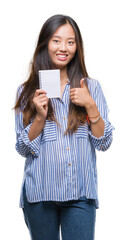 Sticker - Young asian woman holding notebook over isolated background happy with big smile doing ok sign, thumb up with fingers, excellent sign