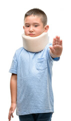 Poster - Dark haired little child injured wearing neck collar with open hand doing stop sign with serious and confident expression, defense gesture