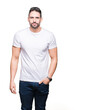 © Krakenimages.com - Young man wearing casual white t-shirt over isolated background Relaxed with serious expression on face. Simple and natural looking at the camera.