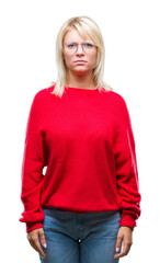 Poster - Young beautiful blonde woman wearing sweater and glasses over isolated background skeptic and nervous, frowning upset because of problem. Negative person.