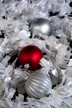 Red And Silver Baubles On Silver Paper Strips