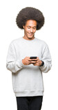 Fototapeta  - Young african american man with afro hair using a smartphone with a happy face standing and smiling with a confident smile showing teeth