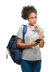 Canvas Print - Young beautiful afro american student woman holding backpack over isolated background serious face thinking about question, very confused idea