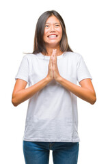 Sticker - Young asian woman over isolated background begging and praying with hands together with hope expression on face very emotional and worried. Asking for forgiveness. Religion concept.