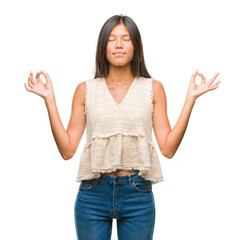 Canvas Print - Young asian woman over isolated background relax and smiling with eyes closed doing meditation gesture with fingers. Yoga concept.