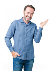 Sticker - Handsome middle age elegant senior man over isolated background smiling cheerful presenting and pointing with palm of hand looking at the camera.