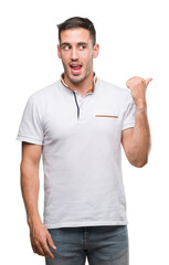 Canvas Print - Handsome young casual man wearing white t-shirt pointing with hand and finger up with happy face smiling