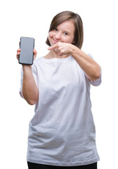 Sticker - Young adult woman with down syndrome showing smartphone screen over isolated background very happy pointing with hand and finger