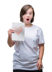 Sticker - Young adult woman with down syndrome holding red heart card over isolated background scared in shock with a surprise face, afraid and excited with fear expression