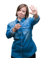 Poster - Young adult woman with down syndrome drinking water over isolated background with open hand doing stop sign with serious and confident expression, defense gesture